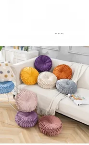 Detailed texture of round pleated velvet pumpkin cushions in various vibrant colors