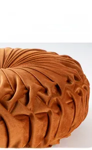 Close-up of thick amber velvet pumpkin cushion showing radial handmade pleats