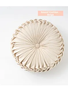 Detail of round pleated beige pumpkin cushion with velvet texture and center button