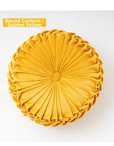 Close-up of golden yellow pumpkin pleated cushion with velvet texture and center button