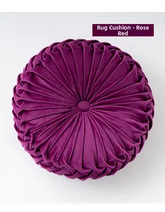 Detail of rose red pleated velvet pumpkin cushion with a central decorative button