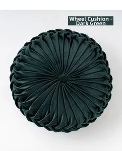 Detailed top view of dark green velvet pleated pumpkin cushion with center button