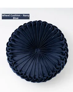 Detailed view of navy blue pleated velvet round wheel cushion with center button