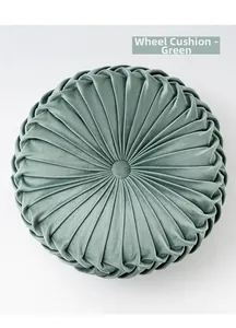 Detail of cyan velvet wheel cushion showing pleated texture and central button design