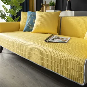 Detail of yellow quilted sofa cover with 3D wave texture and non-slip latex backing