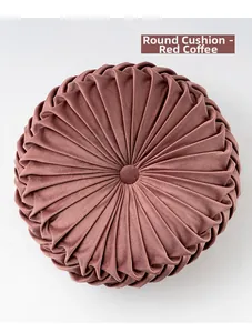Macro shot of the red coffee velvet wheel cushion showing pleated texture and button detail