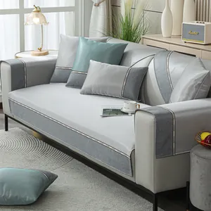 Detail of chenille sofa cover with woven CHANGE label and modern blue-grey fabric texture
