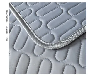 Close-up of grey ice silk sofa mat with oval quilted texture and cooling fabric surface