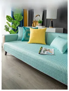 Close-up of wavy quilted cooling silk sofa mat in aqua green with matching pillow covers