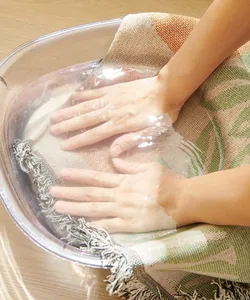 Detailed view of hand washing the American country cotton sofa cover with fringe details