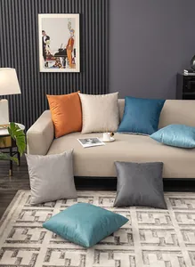 Modern square waterproof cushions in diverse colors on a cozy sofa setting