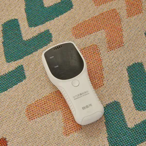 Close-up of portable air quality detector showing HCHO and TVOC display on woven mat