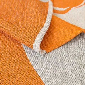 Modern orange and beige woven sofa cover with thick texture and abstract curved patterns