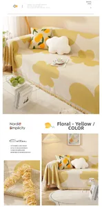 Detail of warm yellow cotton sofa cover with floral pattern and fringe decorative edge