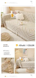 Detail of khaki cotton sofa cover featuring geometric texture and elegant fringe edges