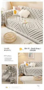 Detail of Nordic grey geometric cotton sofa cover with knit tassels and soft texture