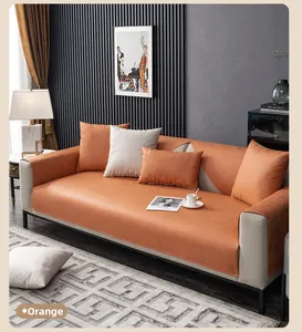 Detail of orange tech-fabric sofa cover with waterproof texture and modern leather-like finish