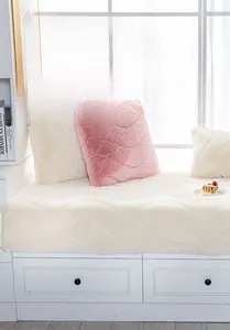 Detail of plush shaggy bay window mat with wave quilting and matching pillows