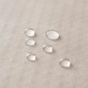 Waterproof light beige tech fabric sofa cover with anti-slip texture and hydrophobic surface