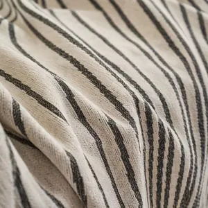 Textured chenille sofa cover with abstract grey stripes on off-white fabric background