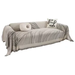 Minimalist cream chenille sofa cover with dark wave pattern and stylish tassel fringe