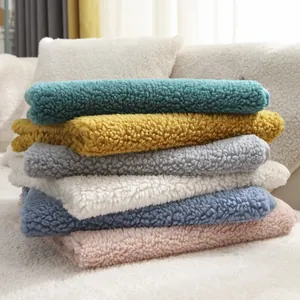 Modern minimalist lamb wool rugs stacked in various soft colors for home decor