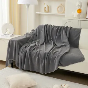 Dark gray textured sofa cover throw with elegant black and white checkered edges