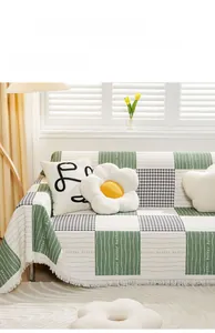 Detail of green and white plaid cotton sofa cover with tassels and better text