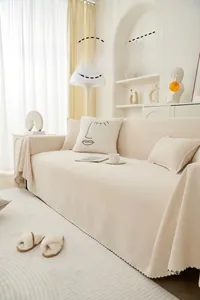Detail of cream chenille sofa cover with wavy stitching and minimalist face pillow
