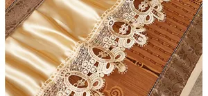 Detail of bamboo sofa mat with champagne satin pleats and elegant lace edging
