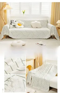 Close-up of cream waffle fabric sofa cover with green wave pattern and tassels