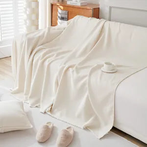 Detail of cream white teddy velvet sofa cover showing waffle texture and knit fabric