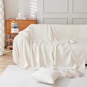 Waterproof teddy velvet sofa cover in cream white with soft texture and fringe edges