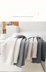 Detailed view of high quality chenille sofa cover with striped texture and fringe edges