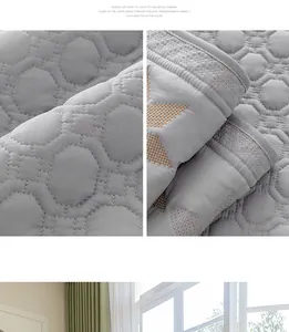 Vista macro de la funda de sofá acolchada gris con patrones geométricos y detalles bordados