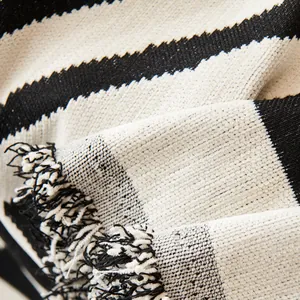 Modern black and white chenille sofa cover with striped weave and fringe details