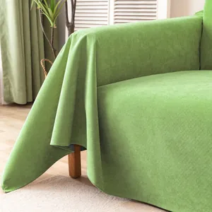 Detail showing the grass green corduroy fabric texture and drape of the sofa cover