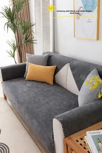 Detail der dunkelgrauen Cord-Sofaabdeckung mit schwarz-weißer Paspelierung am Rand