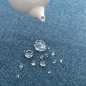 Waterproof navy corduroy sofa cover showing liquid beading on the fabric surface