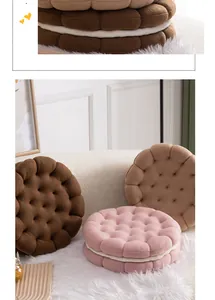Detailed view of biscuit-shaped plush pillows in chocolate, cream, and pink soft fleece