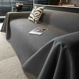 Macro view of dark grey waffle weave texture and premium fabric detail on sofa cover