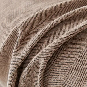 Macro shot of brown chenille herringbone fabric showing rich texture and weaving detail