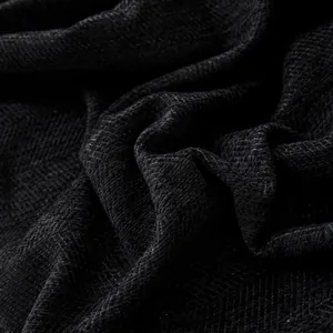 Macro shot of thick black chenille fabric with a herringbone weave for sofa covers