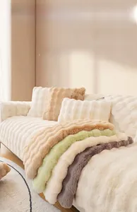Detail of plush faux rabbit fur sofa cushions with soft wavy texture in various colors