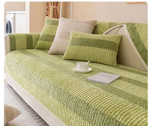 Detail of green striped faux rabbit fur sofa cover with textured non-slip thick fabric