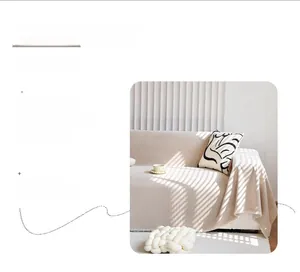 Detail of cream chenille sofa cover showing thick waffle weave texture and fringed edge