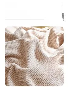 Close-up detail of thickened apricot chenille fabric with premium woven square texture
