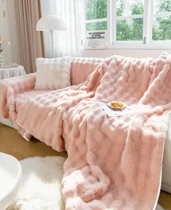 Detail of soft pink plush sofa cover with 3D square texture on a white couch