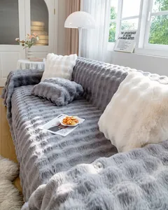 Detailed view of thick grey plush sofa cover with soft wavy textured stripes and cushions