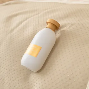 Downtown First Kiss eau de parfum in a frosted matte bottle on beige fabric texture